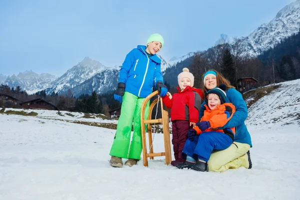 Family Mother Three Children Play Snow Slope Hold Wooden Sledge — Stock Photo, Image