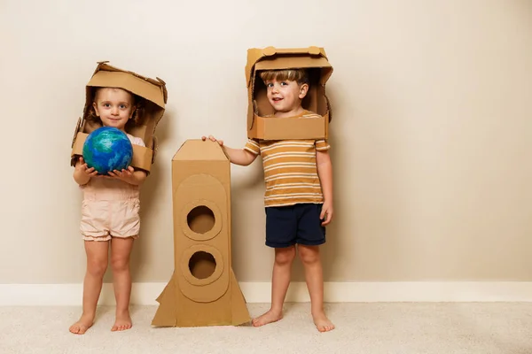 Two Children Stand Cardboard Rocket Astronauts Diy Helmets Holding Planet — Stock Photo, Image