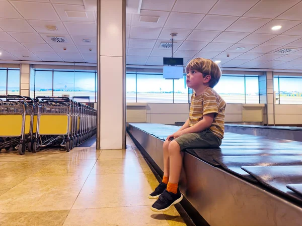 Handsome Small Boy Sit Wait Baggage Conveyor Belt Waiting Checked — Stock Photo, Image
