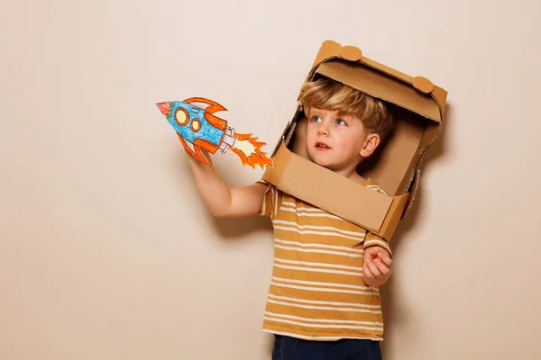 Happy Young Handsome Boy Play Paper Rocket Wearing Cardboard Astronaut — Stock Photo, Image