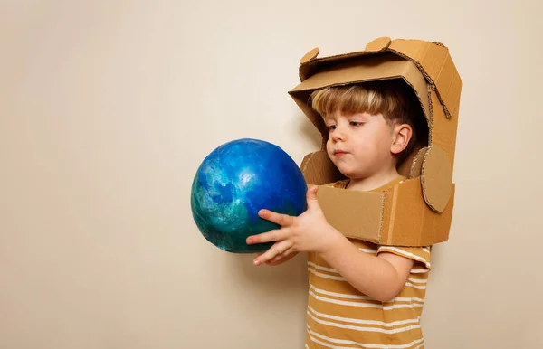 Cute Boy Cardboard Astronaut Helmet Hold Planet Earth Blue Green — Stock Photo, Image