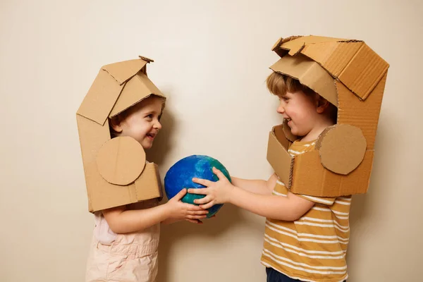Two Beautiful Children Astronaut Cardboard Toy Helmet Lovely Hold Planet — Stock Photo, Image