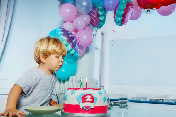 stock image Happy little boy blow candles on the birthday cake party for 2 years old celebration