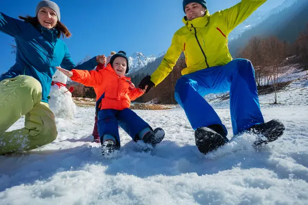 Dynamic Shot Two Parents Jumping Snow His Little Son Bright — Stock Photo, Image