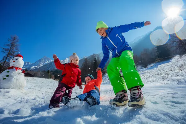 Happy Kids Jumping Falling Sparkling Snowy Field Sunny Mountains Enjoy — Stock Photo, Image