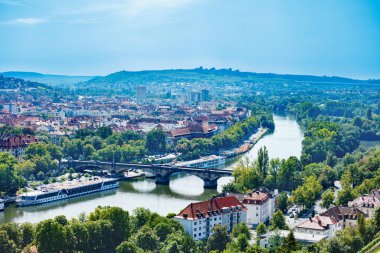 A stunning aerial view of a picturesque town Wurzburg, where a river Main meanders amidst green surroundings and charming houses, Bavaria, Germany clipart