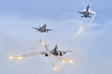 Jet fighters firing chaff flare during training clipart