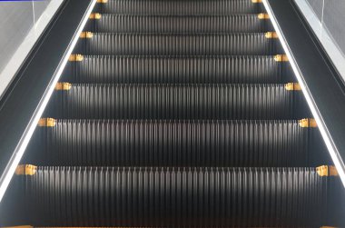 Escalators at night, illuminated by lights                               