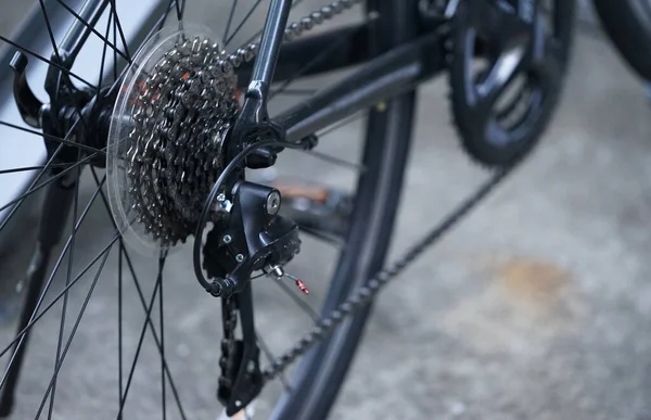 道路脇に駐輪する自転車の後輪のギアシフトとタイヤ — ストック写真