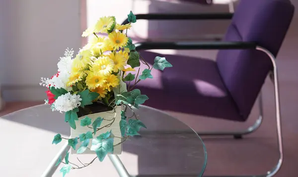 Flowers on a glass table in a sunny room
