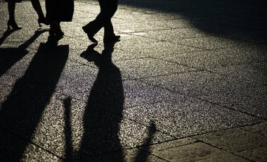 Akşamları kaldırımda yürüyen bir insanın silueti.                              