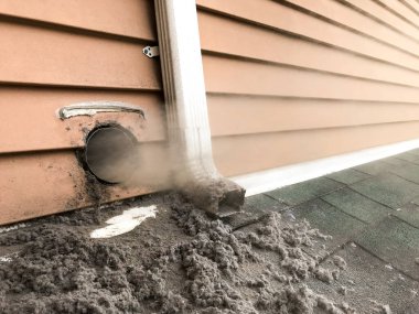 Lint collected from dryer machine is bloving out from vent during cleaning