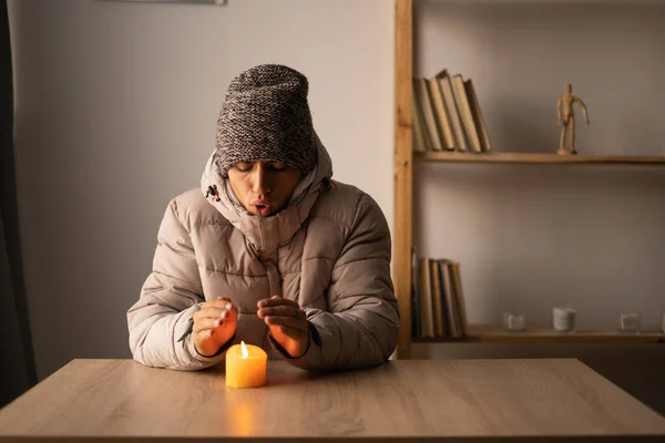 Ijskoude Jongeman Winterkleding Verwarmt Handen Brandende Kaars Stopzetting Van Verwarming — Stockfoto