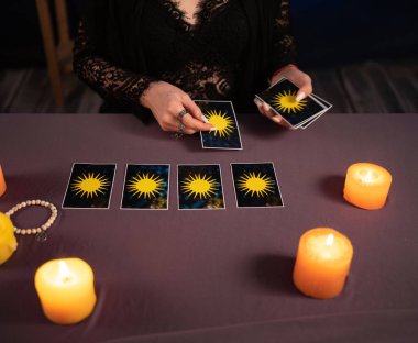 Falcı elleri ve tarot kartları ahşap masada. Öngörü kavramı.
