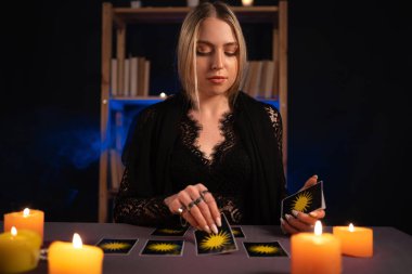 Fortune teller reading tarot cards. The concept of divination, astrology and esotericism clipart