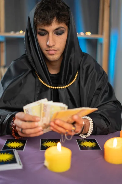 Male Fortune Teller Reading Future Tarot Cards Light Candle Concept — Stock Photo, Image