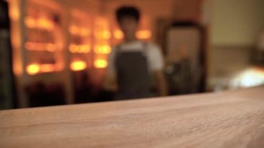 Barmen tezgahta alkol kokteyli servis ediyor. Arkaplan bulanıklığı