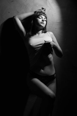 dark female silhouette, hands and face. art portrait. photo of body woman. Copy space