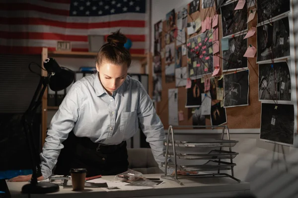 Detective working at desk in her office, copy space