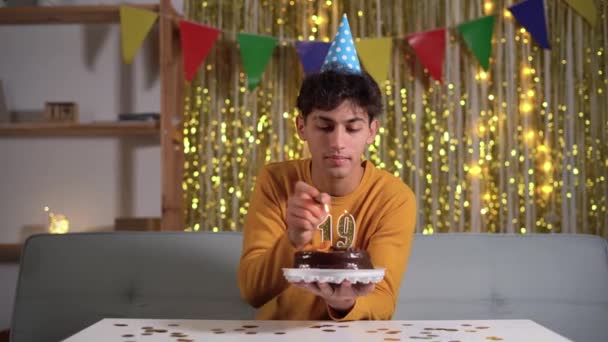 19Th Birthday Young Man Lighting Number Candle Cake Making Wish — Stockvideo
