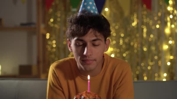 Smiling Young Man Blows Candles His Birthday Cake Celebration Friends — Wideo stockowe