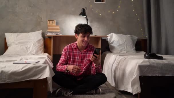 Happy Young Arab Boy Teenager Sitting Floor College Dorm Holding — Vídeos de Stock