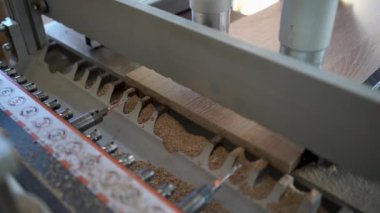 close-up of a drilling machine makes a hole in a wooden slab or mdf. The process of production and manufacture of wooden furniture in a factory and woodworking industry