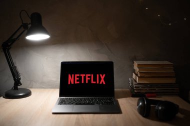 Ukraine, Odessa January 9, 2023: Table with laptop and Netflix logo. global provider of streaming movies and series. Watching movies in an online cinema.