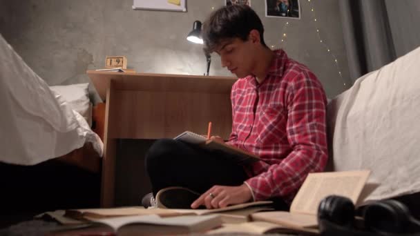 Young Arab Student Sits Night Floor Hostel Open Paper Books — Video Stock