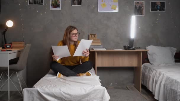 Teenager Girl Student Glasses Sits Bed College Dormitory Holding Sheets — Stock video