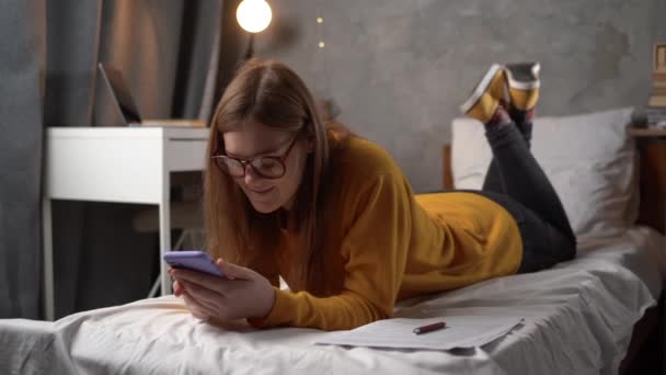 Teenager Girl Student Glasses Lies Bed College Dormitory Holding Smartphone — 图库视频影像