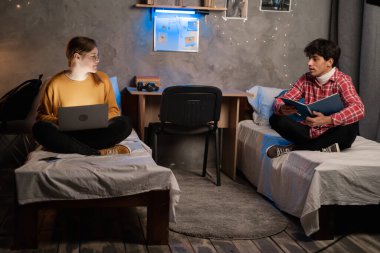 Students man and woman studying in college dormitory, preparing for upcoming tests and exams. Copy space