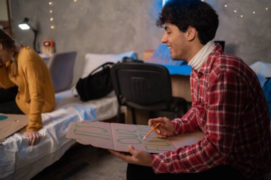 Student activists in dormitory prepare banners for protesting over pollution and global warming. Protest to save planet earth. Handwriting a banner of There is no Planet B. Copy space