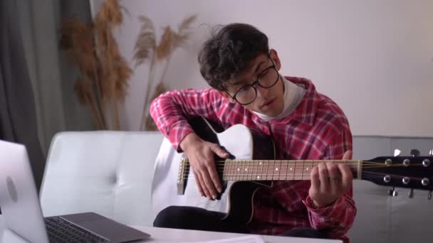 Man Taking Online Guitar Lessons Laptop Home Sitting Sofa Copy — Vídeo de stock