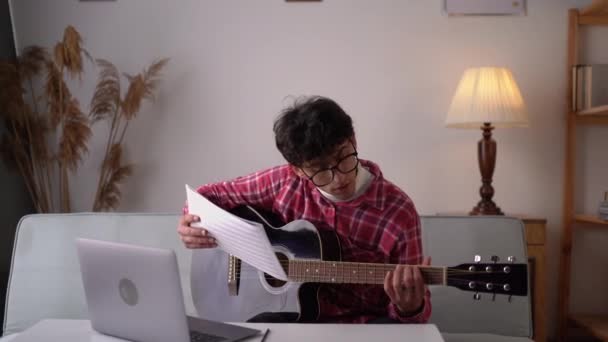 Young Man Playing Acoustic Guitar Watching Online Lesson Laptop While — Stock video