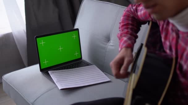 Молодий Чоловік Вчиться Акустичній Гітарі Онлайн Відео Уроками Ноутбуком Клавішею — стокове відео