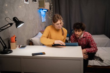 College students sitting at desk in dormitory when having prepare for exam. Copy space