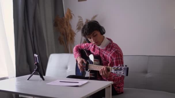 Young Man Playing Guitar Watching Online Lesson Class Smartphone Web — Stockvideo