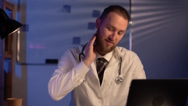 Tired Male Medical Doctor Holding His Back Neck Emphasizing Neck — Stockvideo