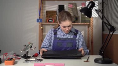 Service repair electronics. Woman make inspection laptop computer before repair. Copy space