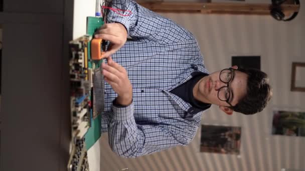 Teenager Testing Circuit Board Checking Multimeter Measurements Sitting His Home — Stock videók