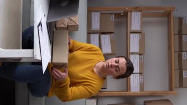 Female warehouse worker or seller packing ecommerce shipping order box for dispatching, preparing post courier delivery package, dropshipping concept.