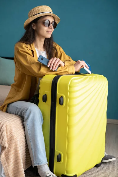 Travel. Woman with suitcase and travel documents. Travel, tourism, vacation, relocation concept. Mental health and travel vacation. Close up