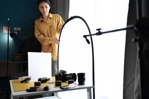 stock image Young woman with professional camera taking skincare beauty product photo in studio. Copy space