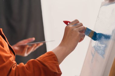 Ressamların ellerini tuvale fırçayla boyayarak yakın çekim yapın. Sanat, yaratıcılık ve insan konsepti. Boşluğu kopyala