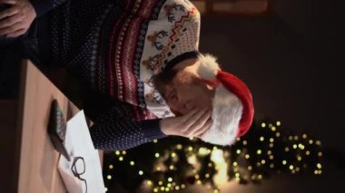 Endişeli adam, Noel tatilinde posta ve banka faturalarını kontrol ediyor. Stresli mali sorun. Dikey video