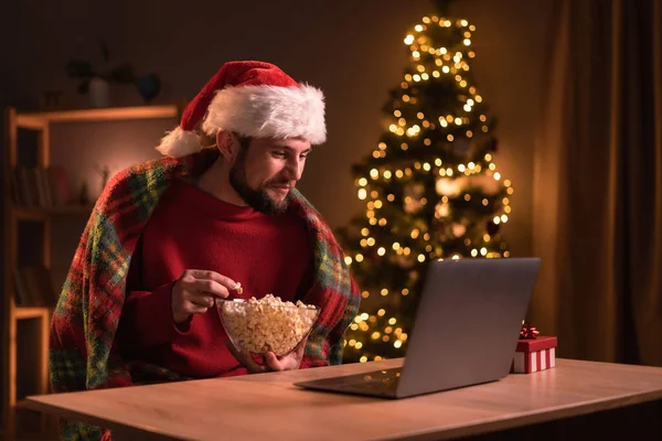 Młody Szczęśliwy Człowiek Nosi Czerwony Pullover Oglądając Nowoczesny Film Świąteczny — Zdjęcie stockowe