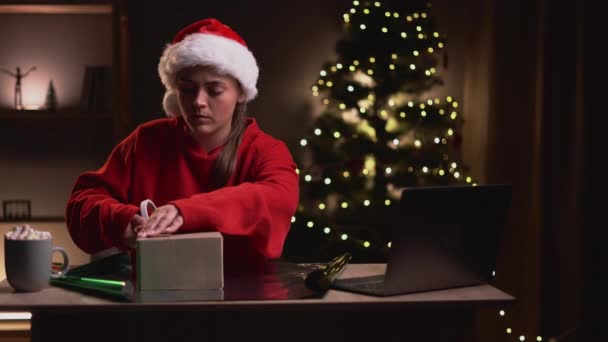 Young Woman Wrapping Christmas Present Sitting Table Laptop Computer Copy — Stock Video