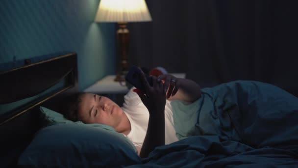 Jonge Slaperige Vermoeide Vrouw Liggend Bed Met Behulp Van Smartphone — Stockvideo