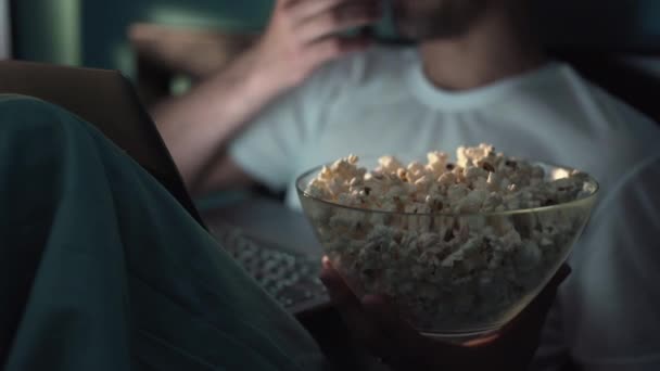 Close Young Man Eating Popcorn While Lying Bed Watching Movie — Stok Video